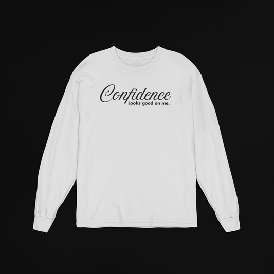 Ash grey long-sleeve shirt with 'Confidence looks good on me' text on a black background