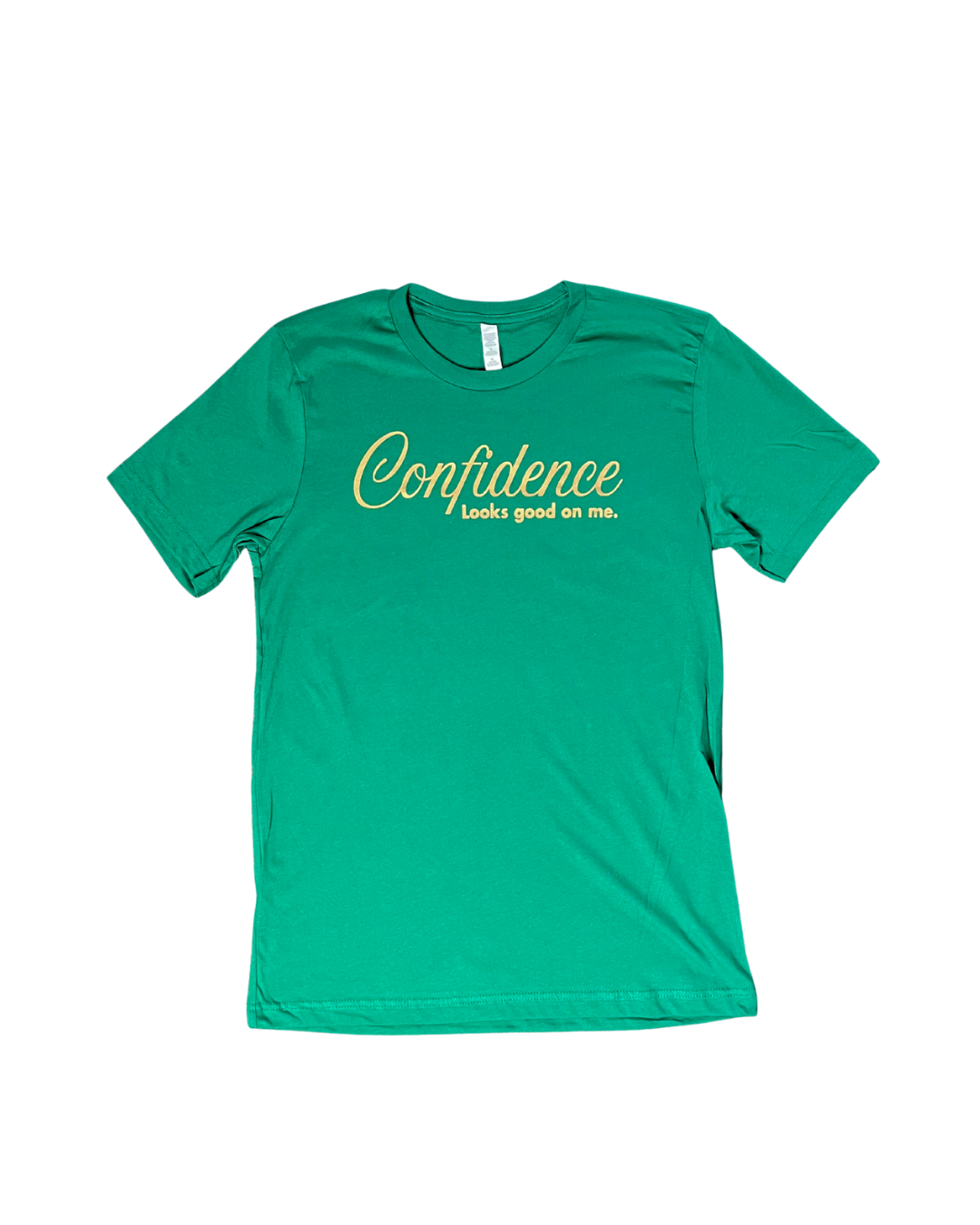 flat lay of kelly green t-shirt with 'Confidence looks good on me' text  in metallic gold, on white background.