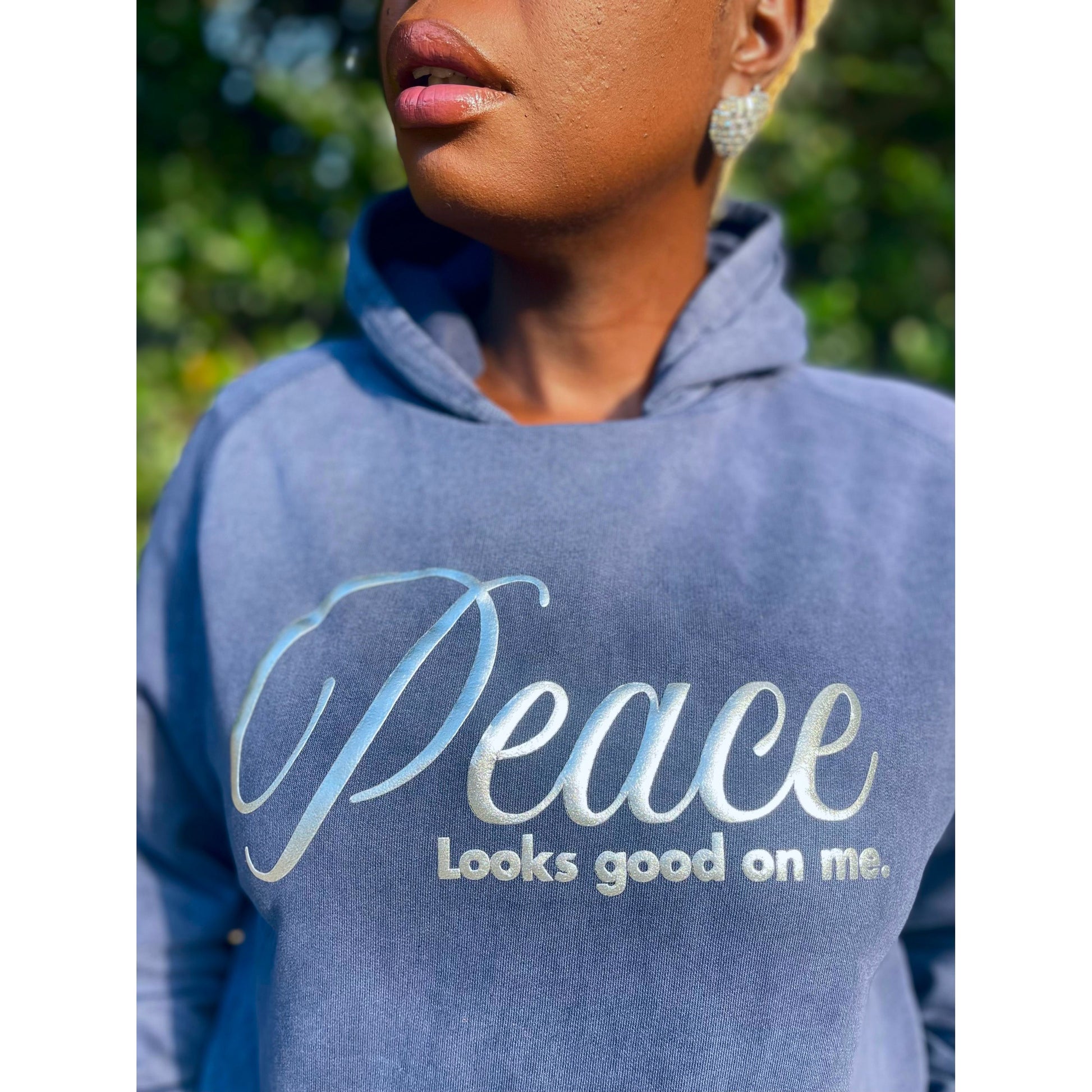 Shamere Young wearing Peace Looks Good on Me hoodie in vintage denim wash with metallic silver lettering - cozy Faith-based apparel for women
