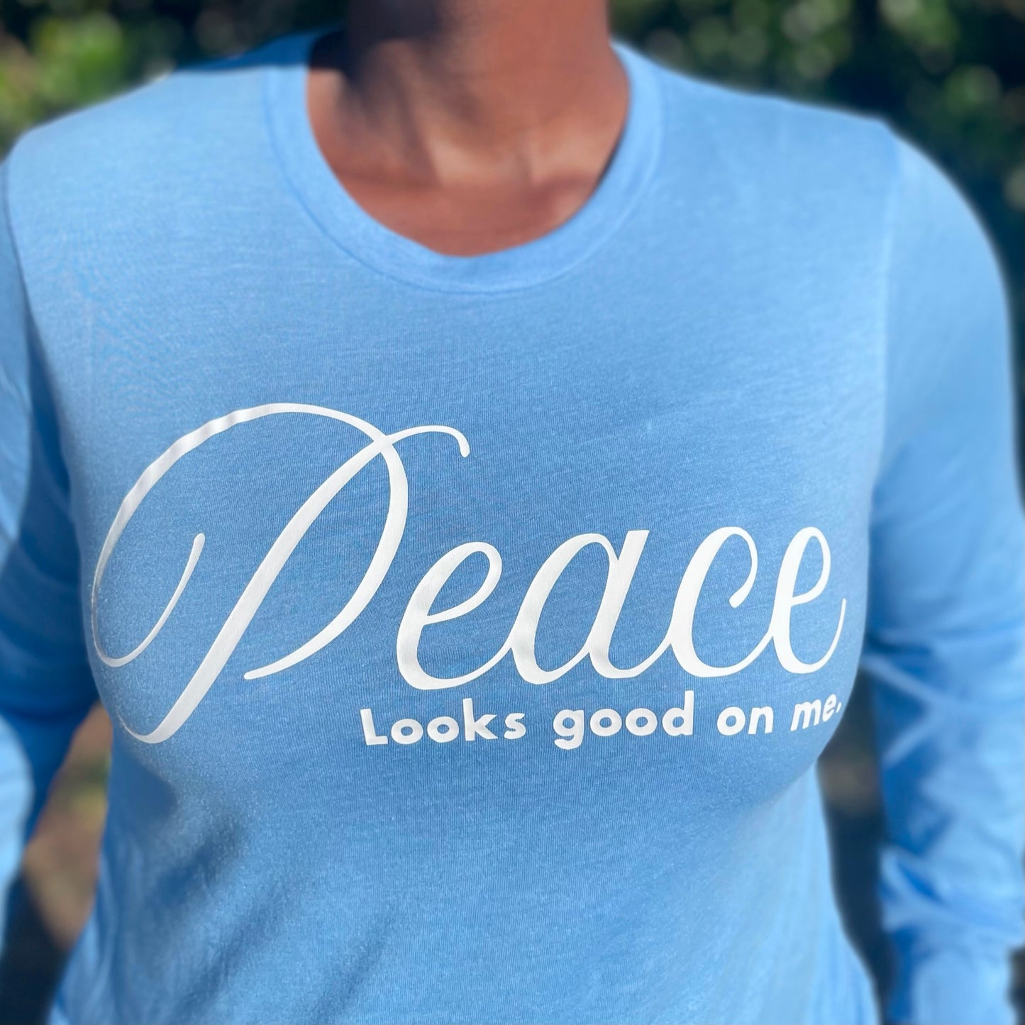 Peace Looks Good On Me Carolina blue long sleeve t-shirt with white lettering — cozy Faith-based apparel for women
