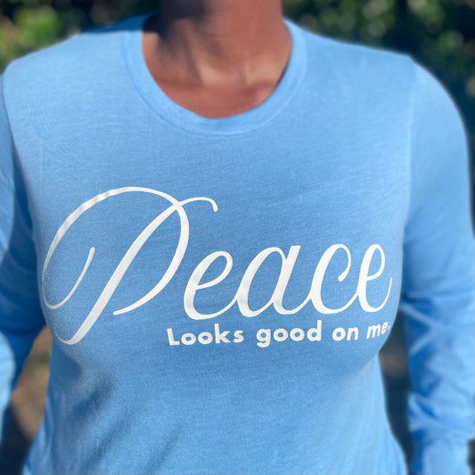 Peace Looks Good On Me Carolina blue long sleeve t-shirt with white lettering — cozy Faith-based apparel for women