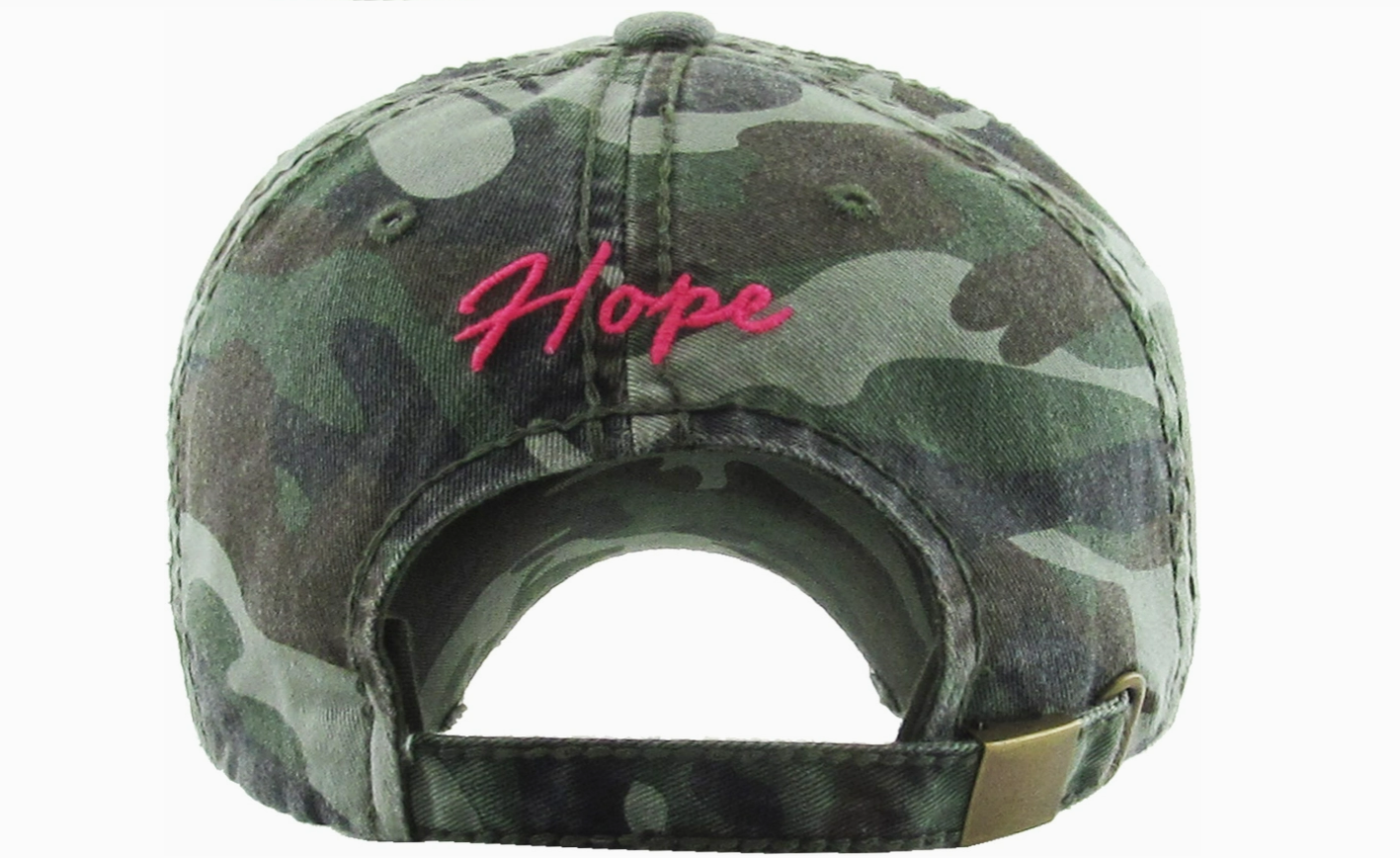 Camouflage cap with 'Hope' embroidered in pink on a white background