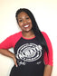 Black woman smiling in a black and red raglan tee featuring the bold white “Validated” stamp design across the chest. Tee has red three-quarter sleeves and a fitted unisex cut.