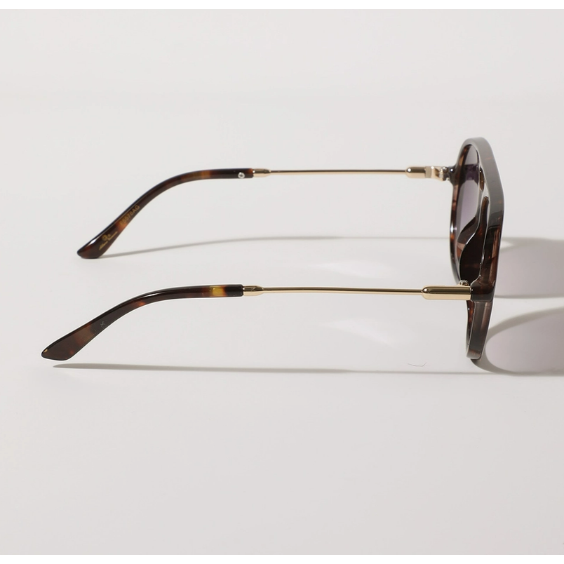 Sunglasses with tortoiseshell frame and gold accents on a light gray background