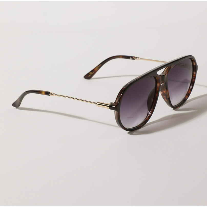 Sunglasses with tortoiseshell frame and dark lenses on a light gray background